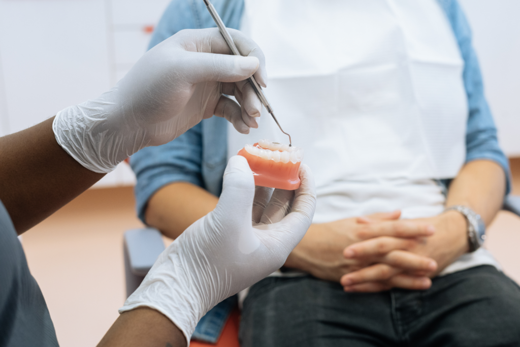 dentist pointing to model of gums