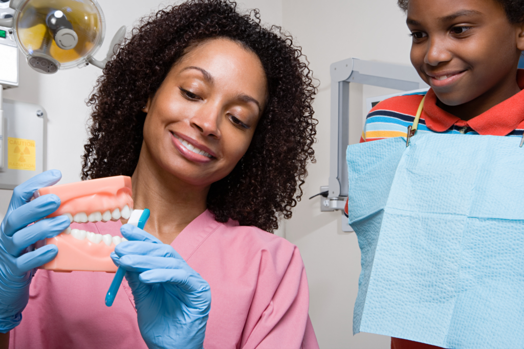 dental hygienist showing how to brush