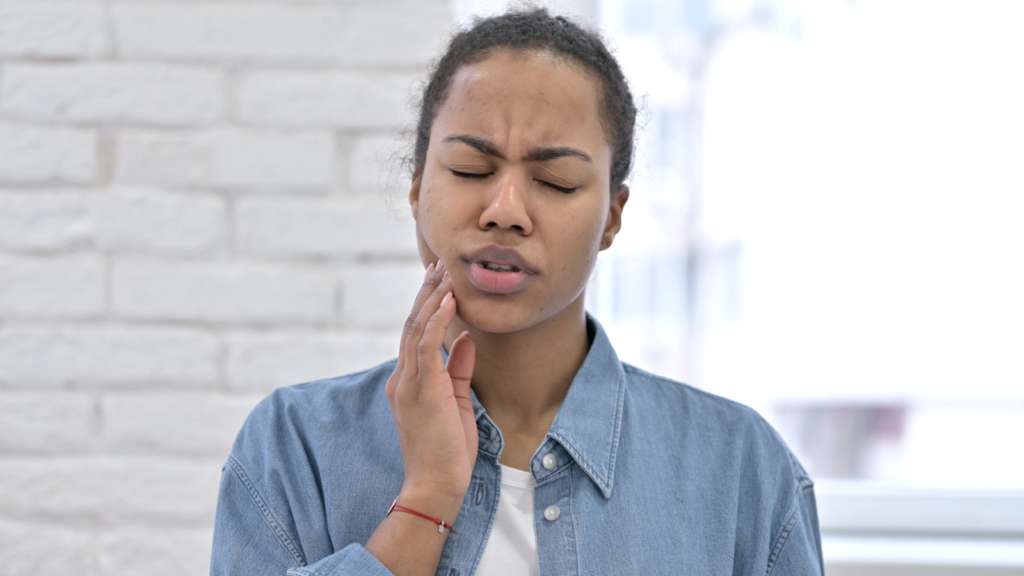 young woman with tooth pain