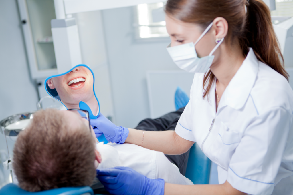 Young female dentist working in her office