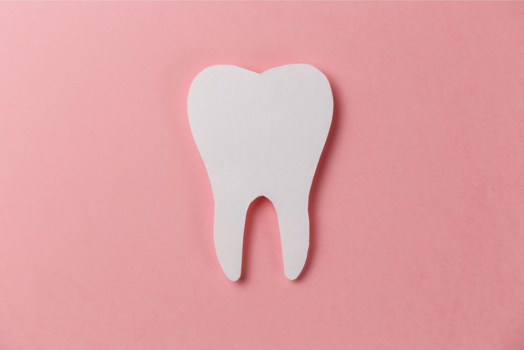 white tooth on pink background