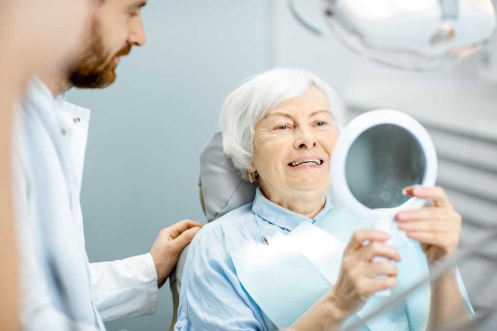 Elderly woman enjoying her smile in the dental office